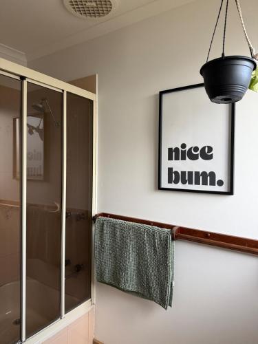 a bathroom with a shower and a picture on the wall at Eunoia at Smiths in Smiths Beach