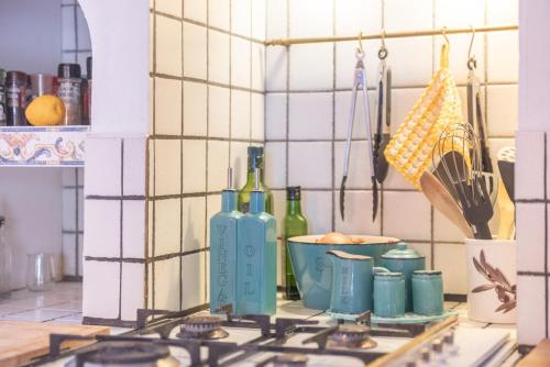 a kitchen with a stove with bottles and a bowl at Casa Vista Monte in Llucmajor