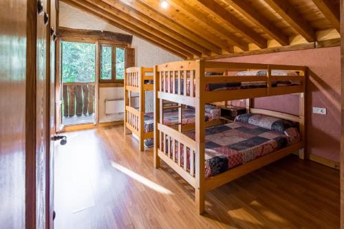 a room with two bunk beds in a cabin at La Hirriria in San Roque de Ríomiera