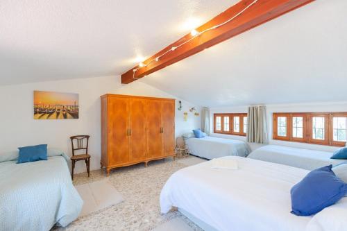 a bedroom with two beds and a large window at Fidalsa Imperial Malibu in Elche