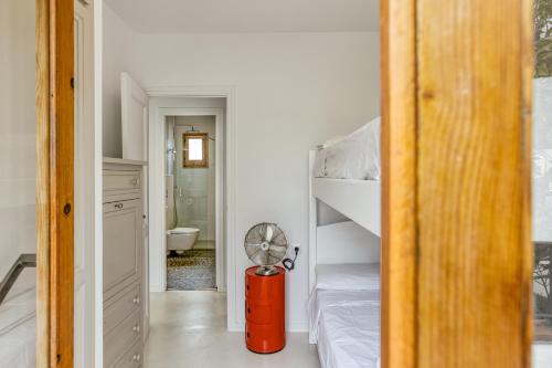 a room with a fan and a bunk bed at Villa la Barrufa in S'agaro