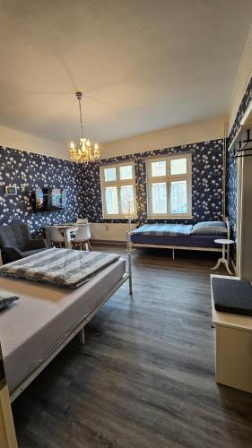 a bedroom with a bed and a couch and chairs at Studio zur »Alten Schmiede« in Laage
