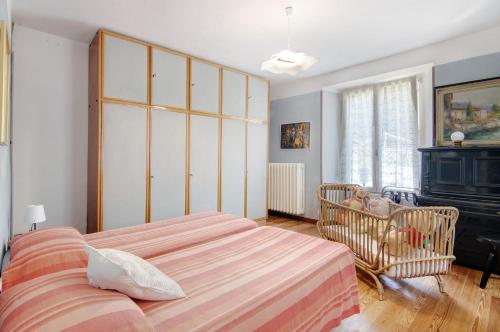 a bedroom with a large bed and a fireplace at Residenza ai Noci in Lanzo dʼIntelvi