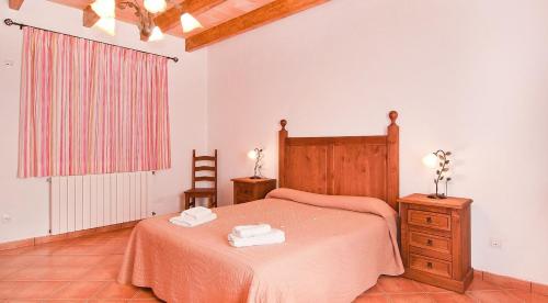 a bedroom with a bed with two towels on it at Can Mates Nou in Campos