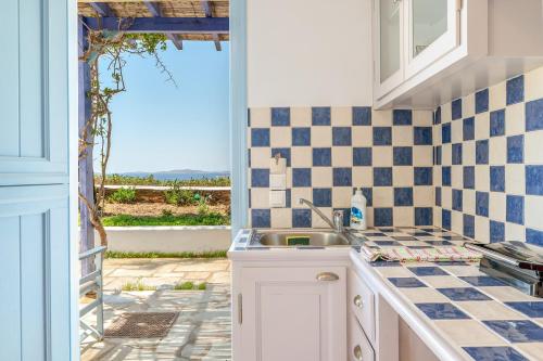 a kitchen with a sink and a window at La Casa Tinos 22 in Tinos