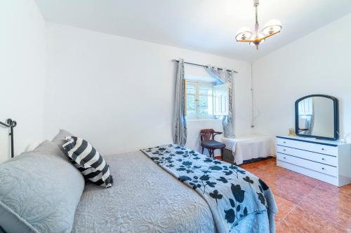a bedroom with a bed and a dresser and a mirror at Casa rural Mccoy 2 in Macael