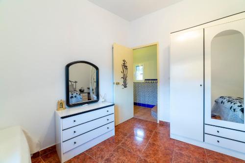 a bedroom with a dresser and a mirror at Casa rural Mccoy 2 in Macael
