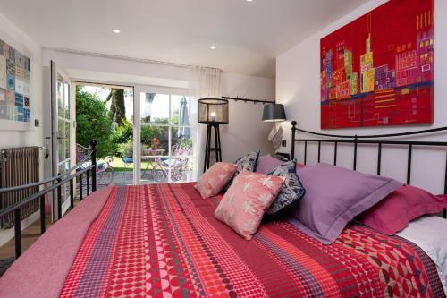 a bedroom with a large bed with pillows on it at Chambre - Spa - Piscine - Sauna in Brech