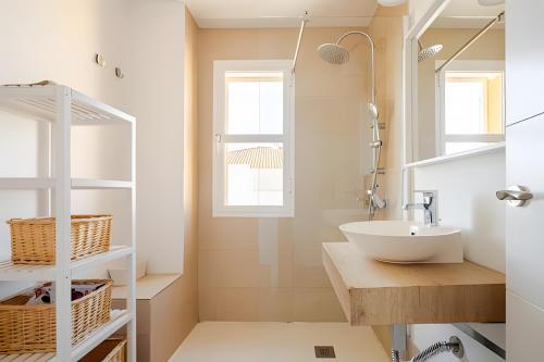 a bathroom with a sink and a mirror at 1 Linea Playa , 3 Dorm Islantilla in Isla Cristina