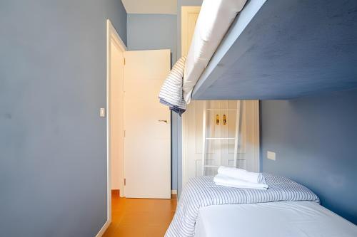 a bedroom with a bunk bed in a blue room at 1 Linea Playa , 3 Dorm Islantilla in Isla Cristina