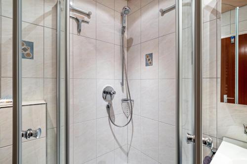 a shower with a shower head in a bathroom at Ferienwohnungen Nordschwarzwald in Freudenstadt