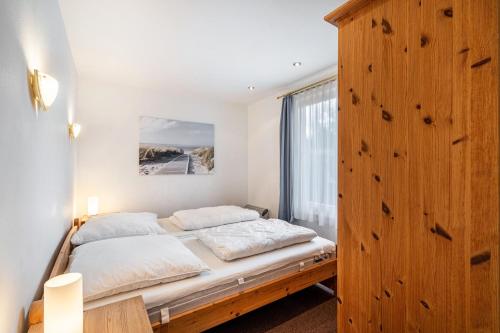 a bedroom with a bed and a large window at Bungalow 71 in Zeulenroda