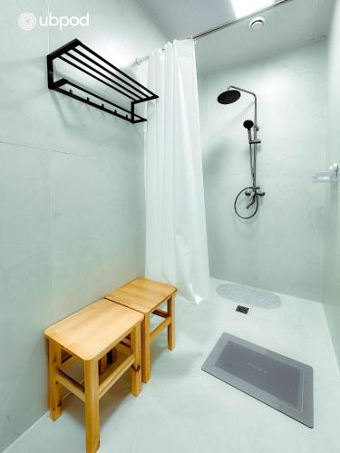 a room with a bench and a shower and a bike at UBPOD- The First Capsule Hotel in Mongolia in Ulaanbaatar