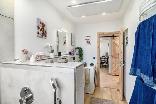 a bathroom with a washer and dryer at Ferienwohnung Wittle in Weiler-Simmerberg
