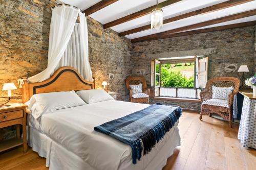 a bedroom with a large bed and a window at Casa Rural Casa Mario in Cangas del Narcea