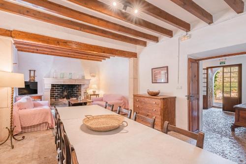 a living room with a table and a fireplace at Can Faveta in Alcudia