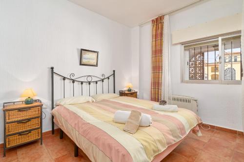 a bedroom with a large bed with two towels on it at Carabeo 19 in Nerja