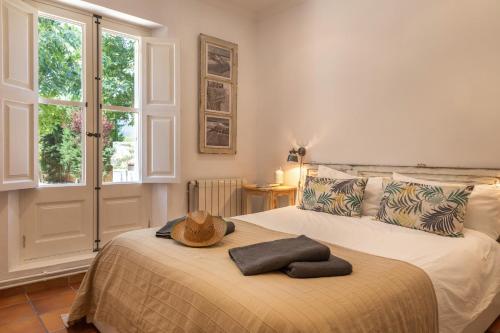 a bedroom with a bed with a hat on it at Finca Can Nou in Sóller