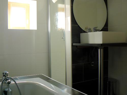 a bathroom with a sink and a mirror at Le Genévrier - Gites Rocheflamme in La Malène