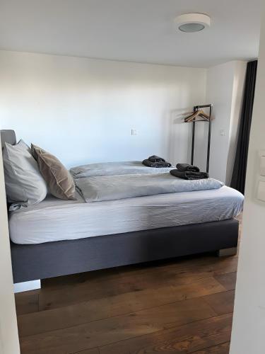 a bedroom with a bed with white sheets at Seeliebe-Reichenau in Reichenau