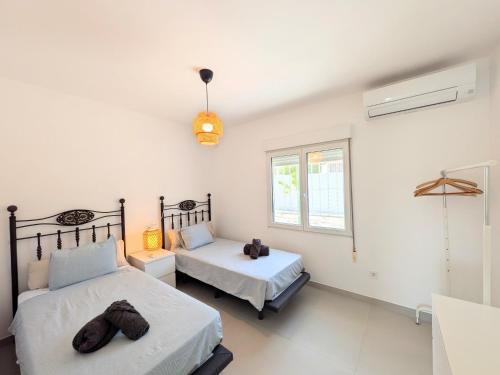 a bedroom with two beds and a window at R-70 Oasis in Ciudad Quesada