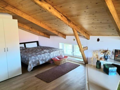 a bedroom with a bed and a wooden ceiling at Altes Landhaus in Behrendorf