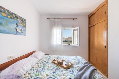 a bedroom with a bed with a tray on it at Hygee in San Javier
