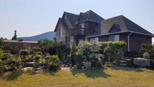 a large house with a garden in front of it at Spring Garden Wando in Wando