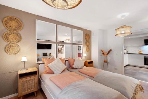 a bedroom with two beds and a living room at Modern und gemütlich- in Teningen in Teningen