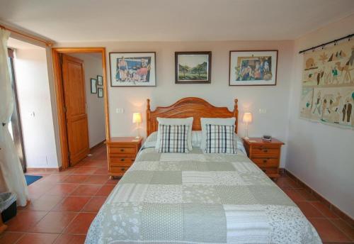 a bedroom with a large bed with a wooden headboard at Finca el Volcan in Mácher