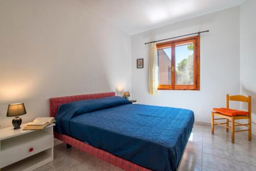 a bedroom with a bed and a desk and a window at Casetta paradiso in Costa Paradiso