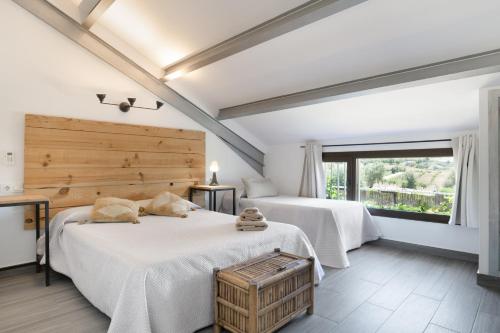 a bedroom with two beds and a large window at Finca encanto in Arcos de la Frontera