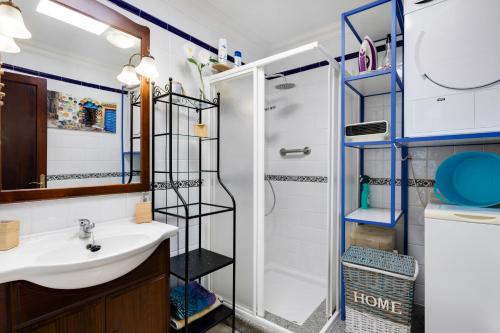 a bathroom with a sink and a shower at El Almendro in Puntagorda