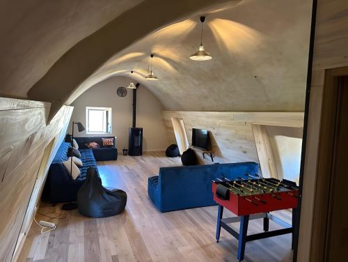 a living room with a blue couch and a table at Domaine avec vue cirque du Levancou in Saint-Georges-de-Luzençon