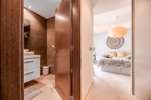 a bathroom with a sliding door leading to a bedroom at Avalon in Benahavís