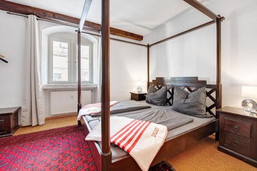 a bedroom with a four poster bed and a window at Zeughaus Ferienwohnung in Überlingen