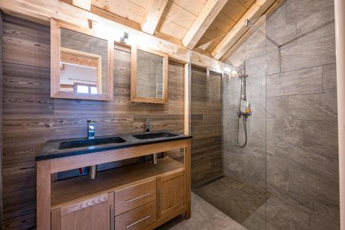 a bathroom with a sink and a shower at Chalet Salt Lake in La Toussuire