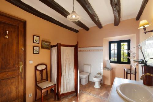 a bathroom with a toilet and a sink at Casa Espigol in El Bruc