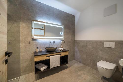 a bathroom with a sink and a toilet at Paflur Lodges Bergtraum in Lasa