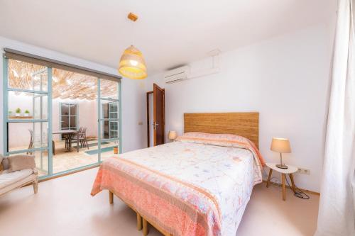 a bedroom with a bed and a large window at Pep Not 47 in Artá