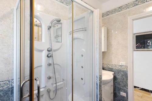 a bathroom with a shower and a toilet at Casa Alizia in Ospedaletti