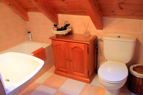 a bathroom with a toilet and a sink and a tub at Casa Es De Bernat 2 in Garós