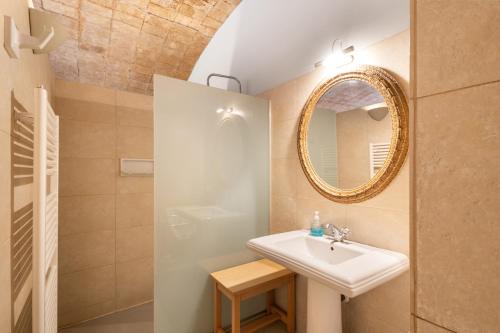 a bathroom with a sink and a mirror at Volta De Ferreres in Olvan