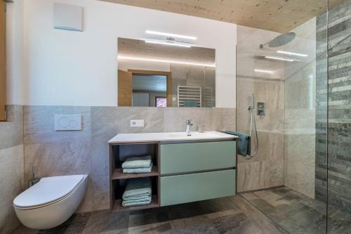 a bathroom with a sink and a toilet and a shower at Pixnerhof Chalet Bonita in Kastelbell-Tschars