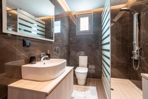 a bathroom with a sink and a toilet at Villa Despina in Rhodes Town