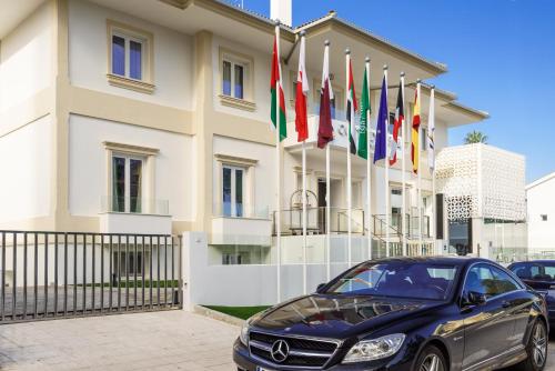 a car parked in front of a building with a flag on it at Costa del Sol Torremolinos Hotel in Torremolinos