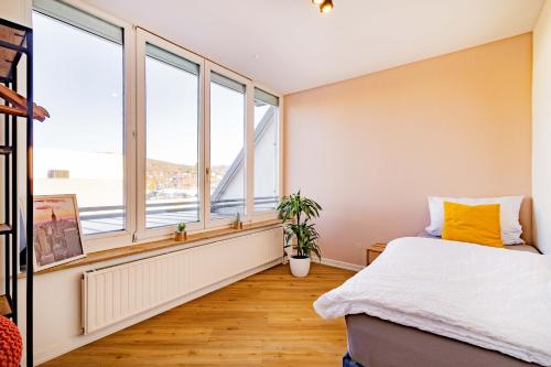a bedroom with a bed and a large window at Kim Fewo 4 in Emmendingen