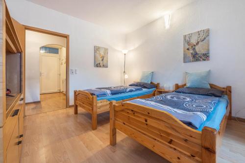 two twin beds in a room with a mirror at Fewo Das Spatzennest in Bad Harzburg