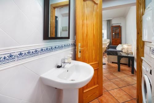 a bathroom with a sink and a mirror at Torre Playa in Torre del Mar