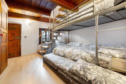 two bunk beds in a room with wooden ceilings at Maison Core' in Fontainamore